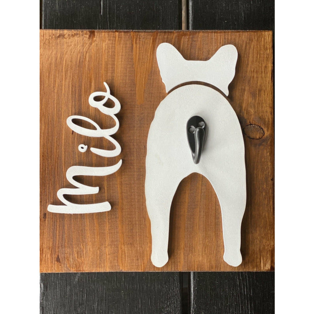Wooden dog leash holder with white french bulldog silhouette, personalized name “Milo,” and black metal hook on rustic wood background.